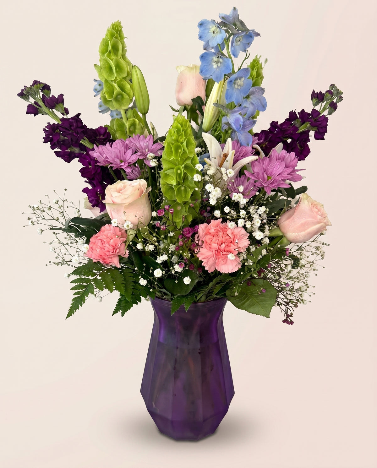 Twilight Garden Tower — tall arrangement of pink roses, purple blooms, and blue delphinium