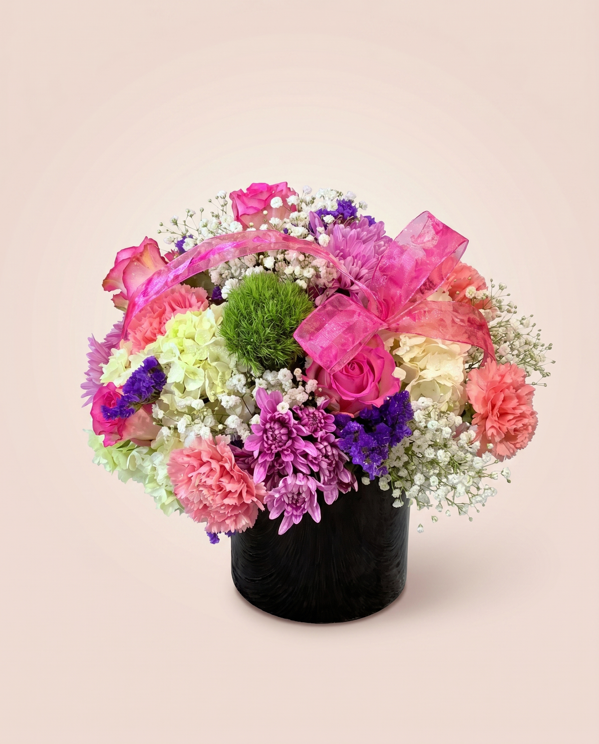 Pink Pop Cube — hot-pink blooms with green accents in a black cube vase
