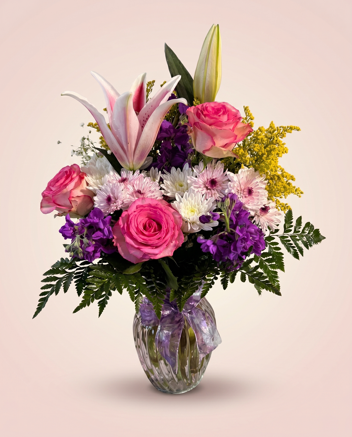Rosy Twilight Bouquet — pink roses, pink lilies, and purple blooms in a glass vase