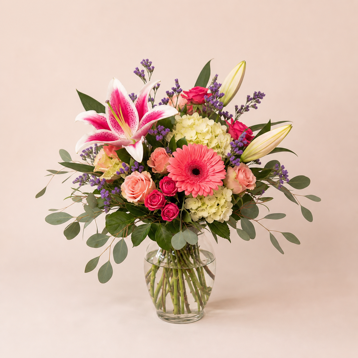 Blush Garden Bouquet smaller Standard arrangement in a rounded clear glass vase