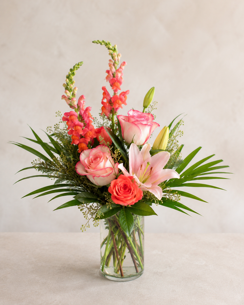 Standard Coral Bloom Bouquet with pink roses, orange rose, pink lily, coral snapdragons and greenery