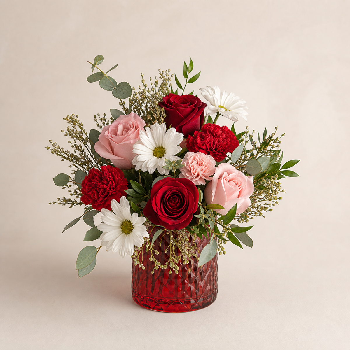 Crimson Embrace smaller Standard fresh flower arrangement in a red glass vase