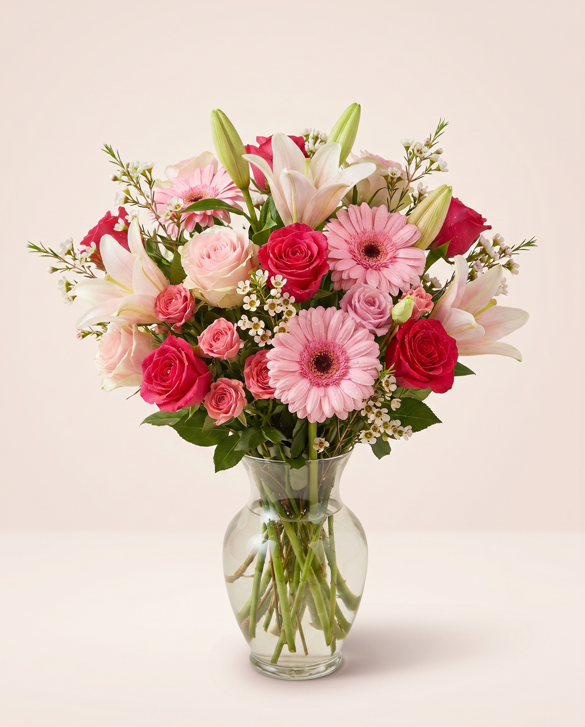 Garden Joy Medley — pink gerbera daisies, roses, and lilies in a clear glass vase