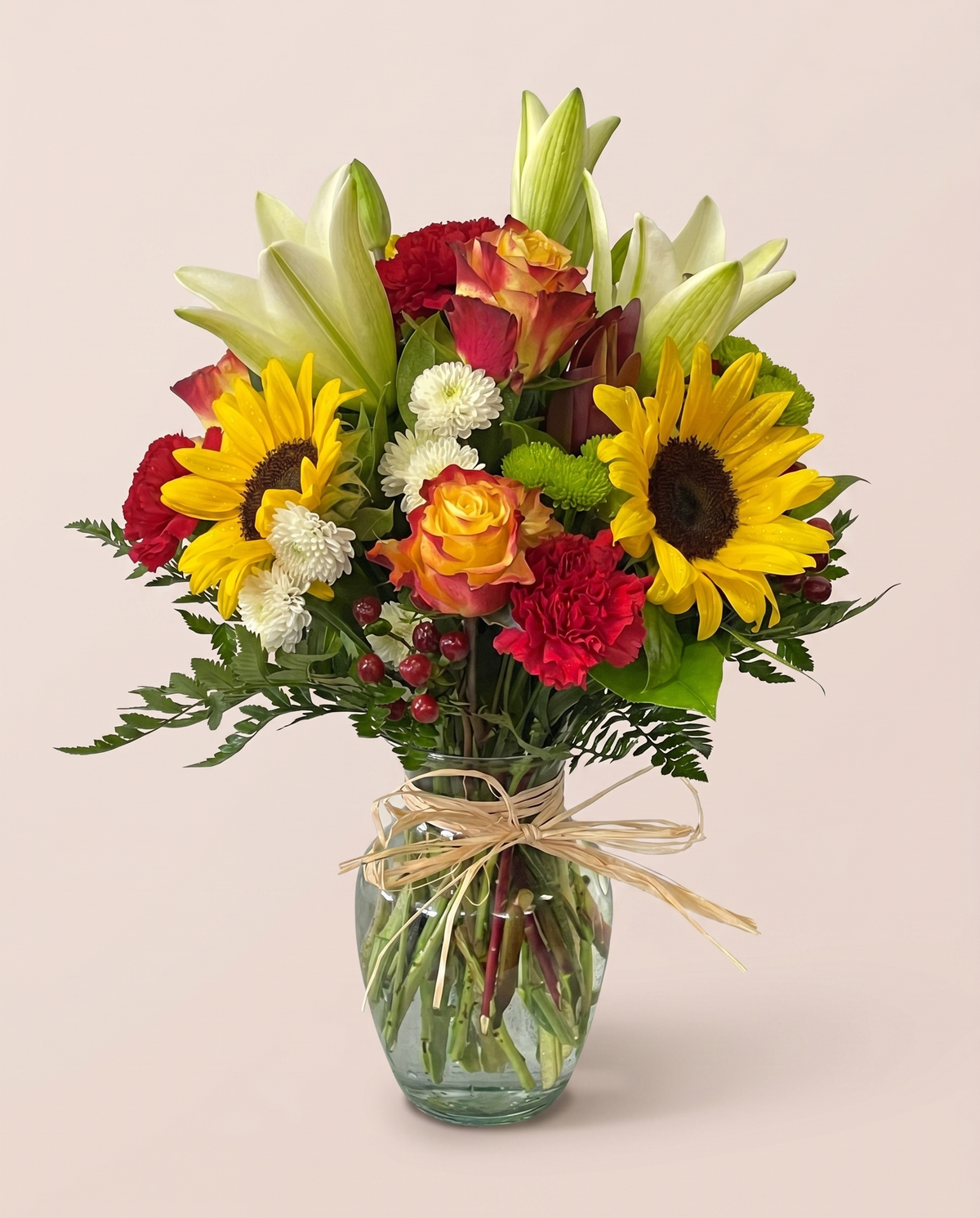 Sunlit Harvest Bouquet — sunflowers, roses, lilies, and carnations in a glass vase