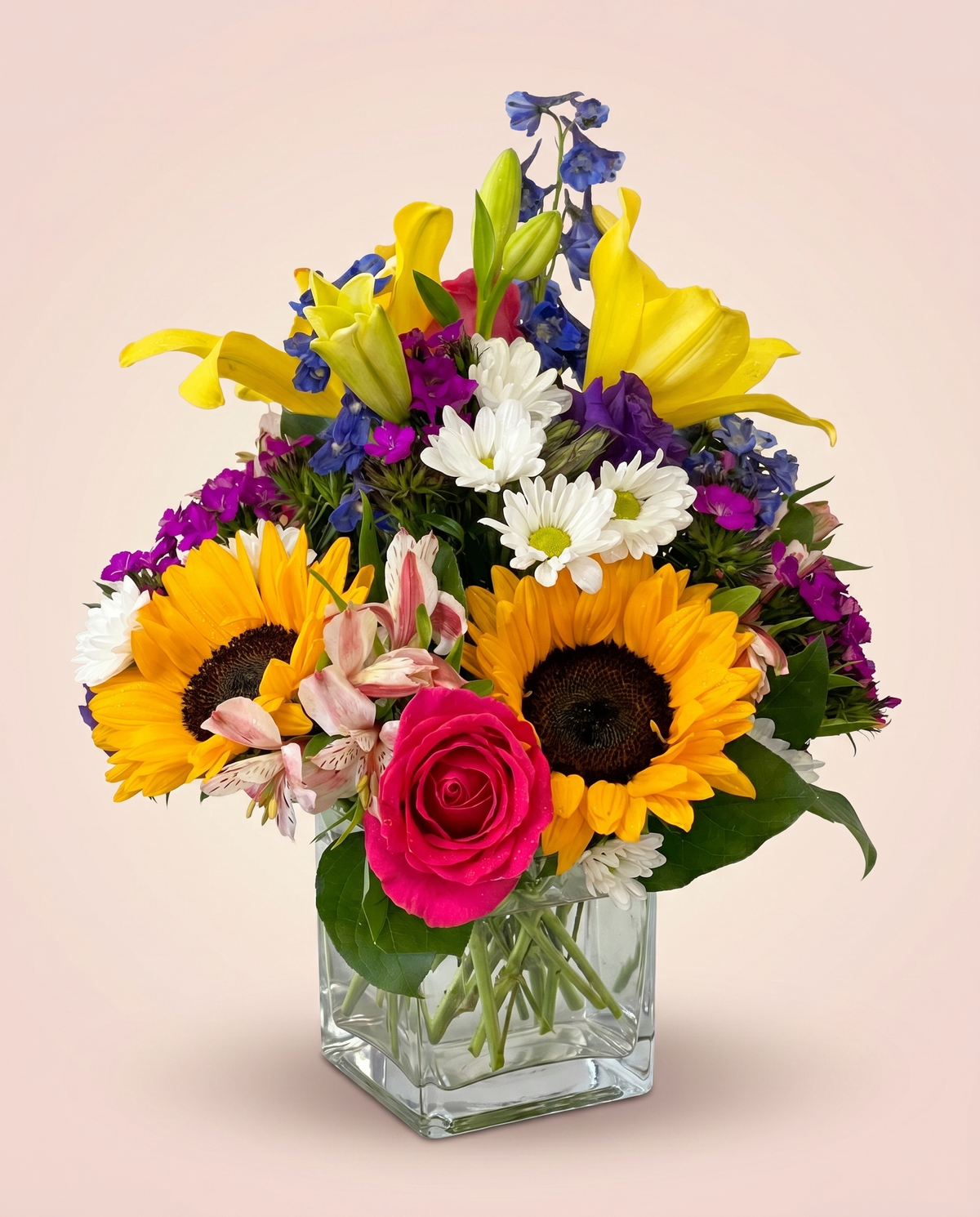 Carnival Garden Cube — sunflowers and bright mixed blooms in a square glass vase