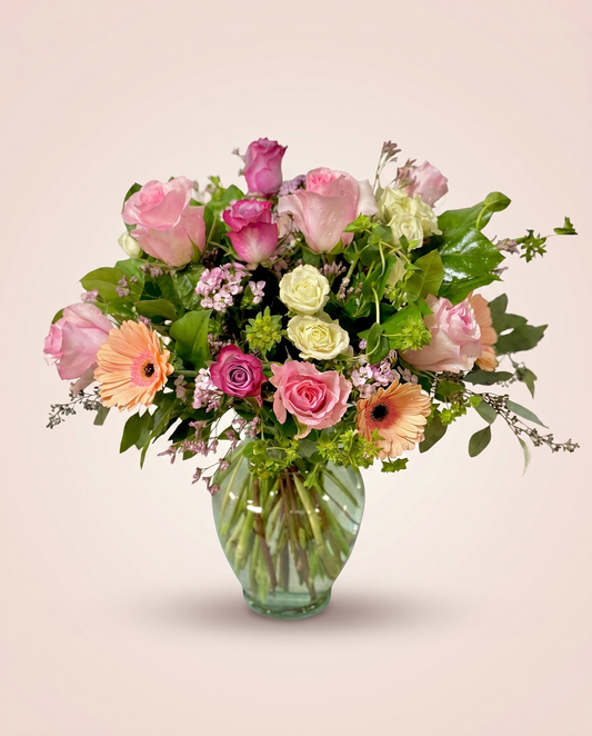 Peach Sorbet Bouquet — soft peach and pink roses in a glass vase