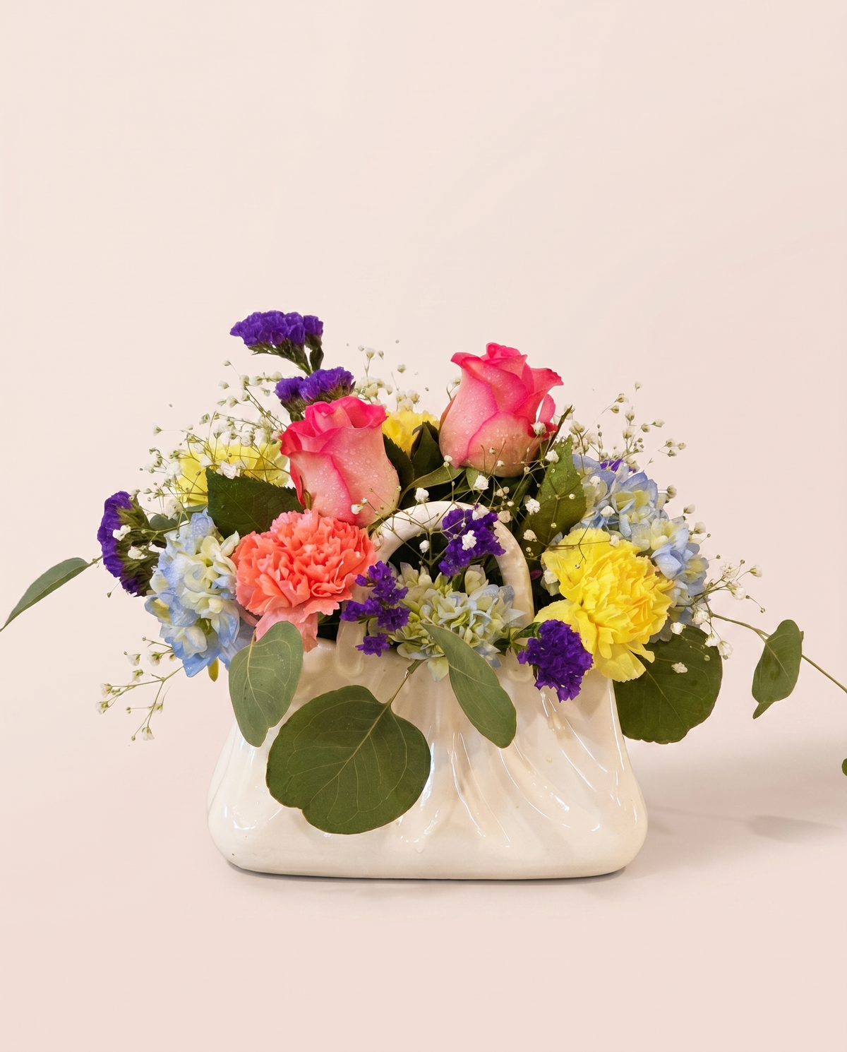 Spring Confetti Bouquet — compact mix of pink, orange, yellow, and purple blooms