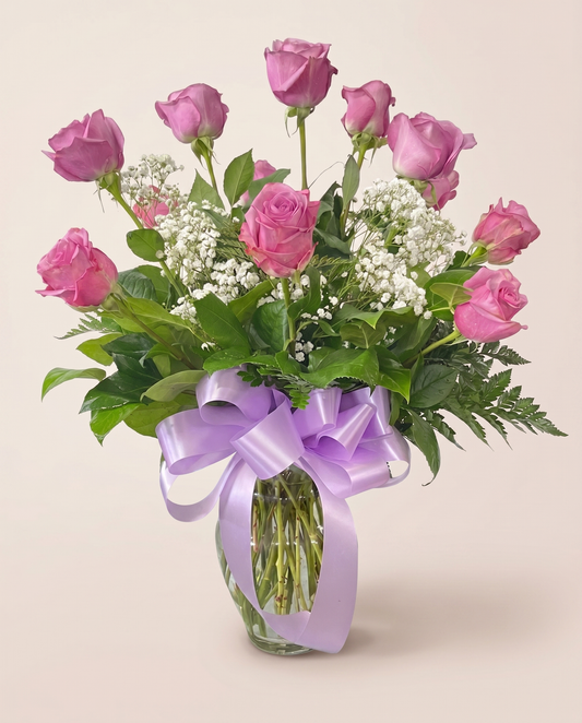 Pure Romance Roses — pink and lavender roses with baby's breath in a glass vase